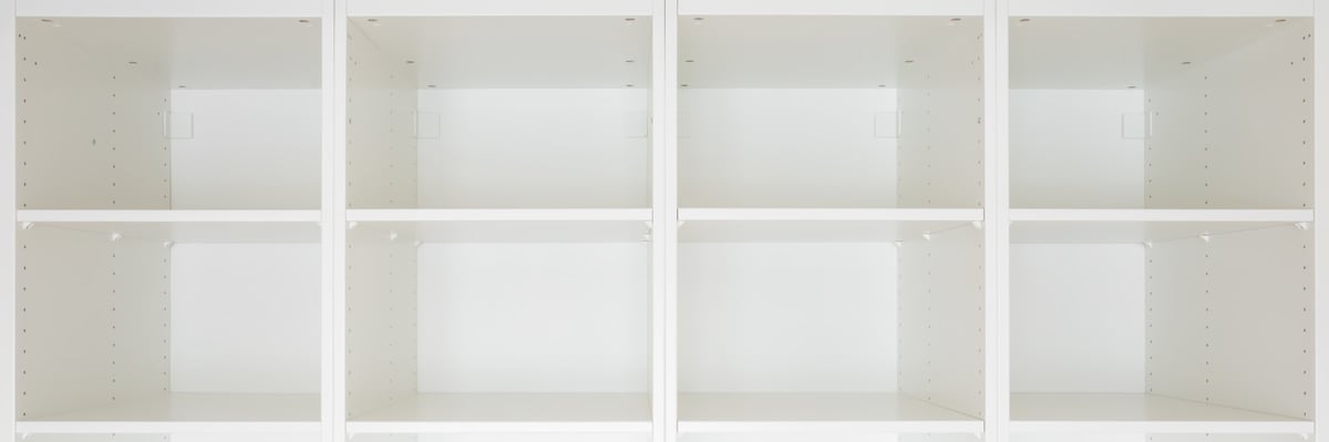 Opened new white wooden wardrobe with empty shelves