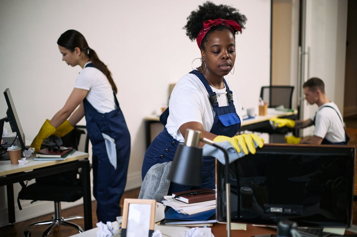 Professional cleaners working in modern office